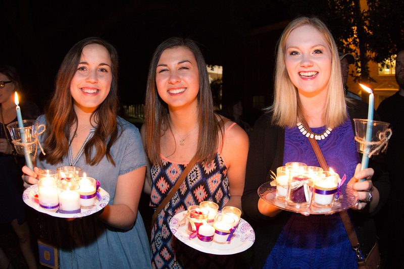 Photo of three girls with candles of graduating seniors Photo of three girls with candles of graduating seniors