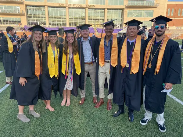 麻豆视频直播 Graduates smile for a picture at Commencement