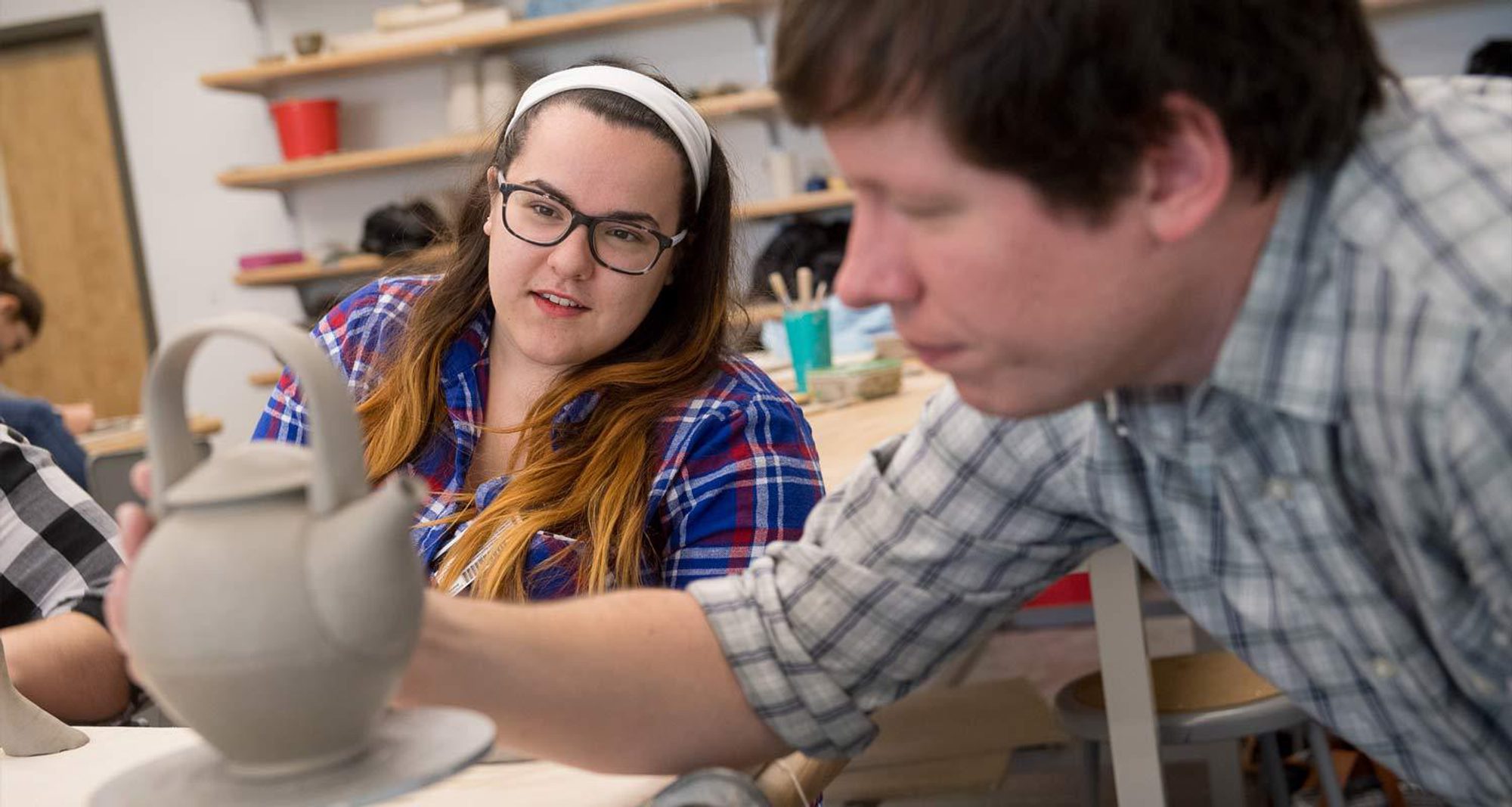 Art Professor David Hill teaches a sculpting class