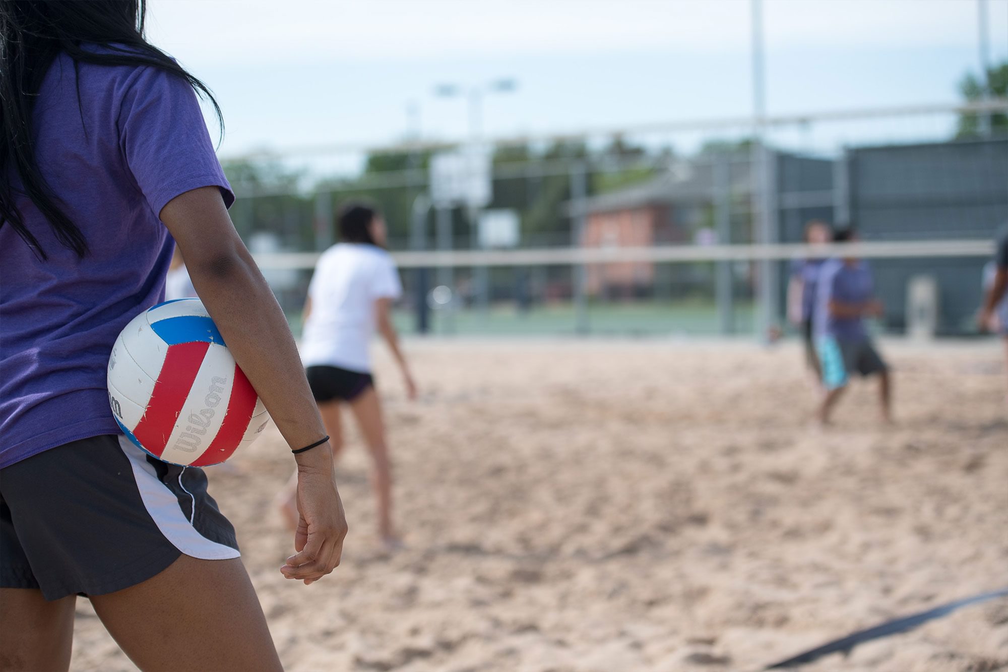 Students play sand volleyball at the Outdoor Recreation Courts