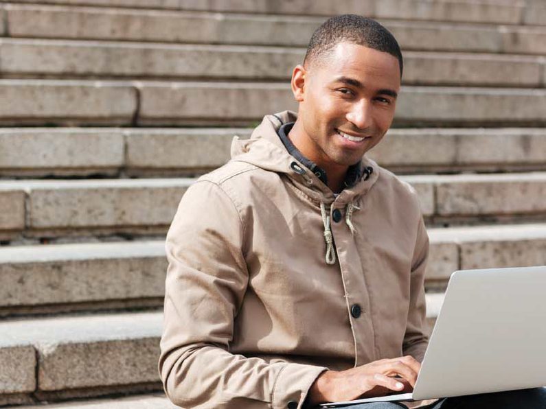 Photo of business student completing courses outdoors Photo of business student completing courses outdoors