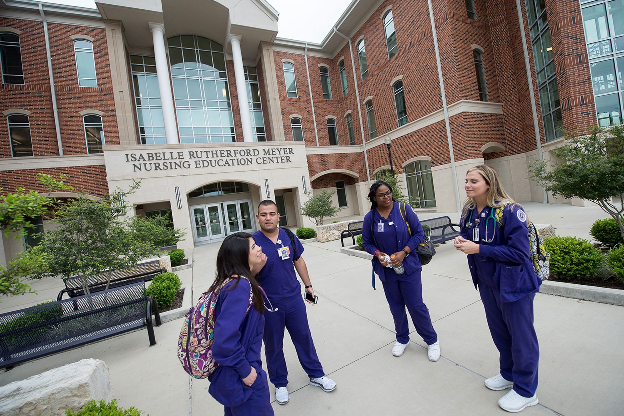 Photos of students talking in front of the Nursing Education Center after class