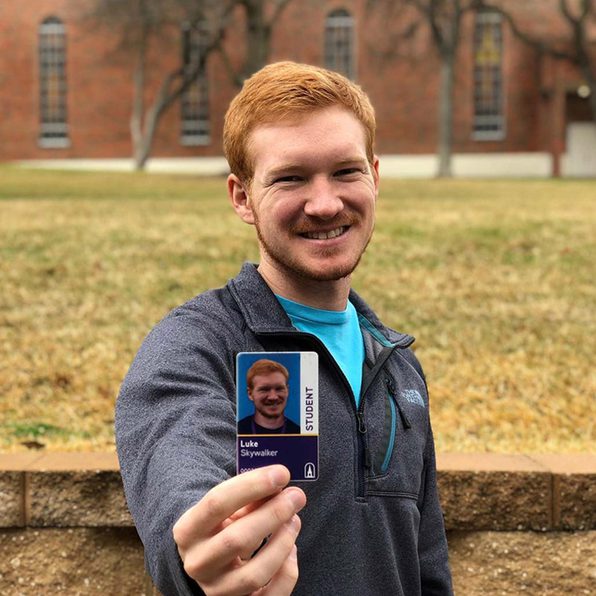 Student holding Cru Card