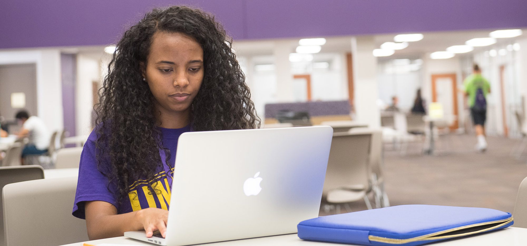 Student working on laptop in Mabee Student Success Center.