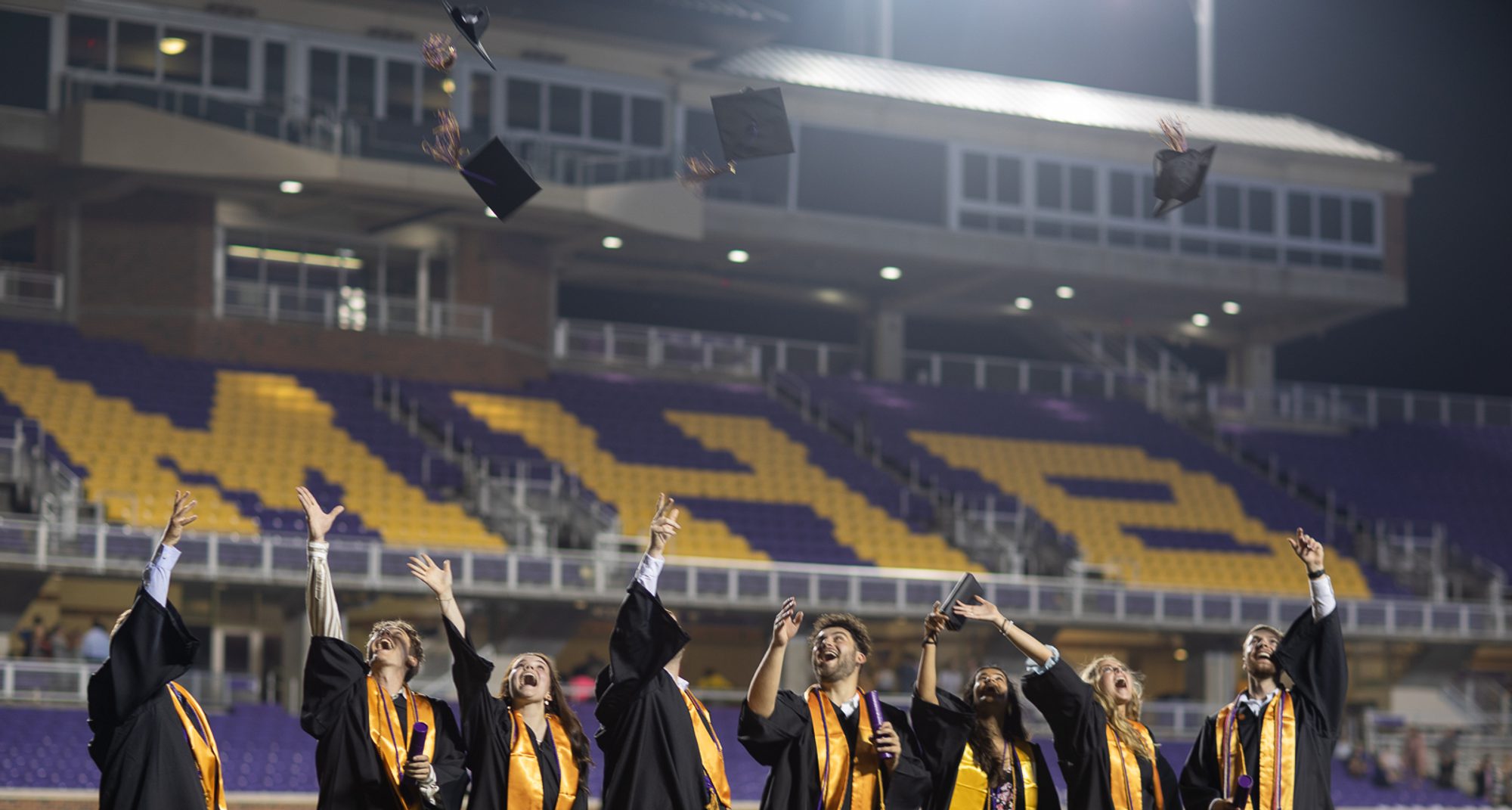 UMHB grads throwing caps