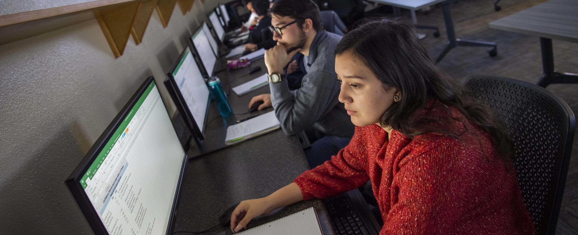 Computer information system degree student analyzing data in UMHB computer lab.