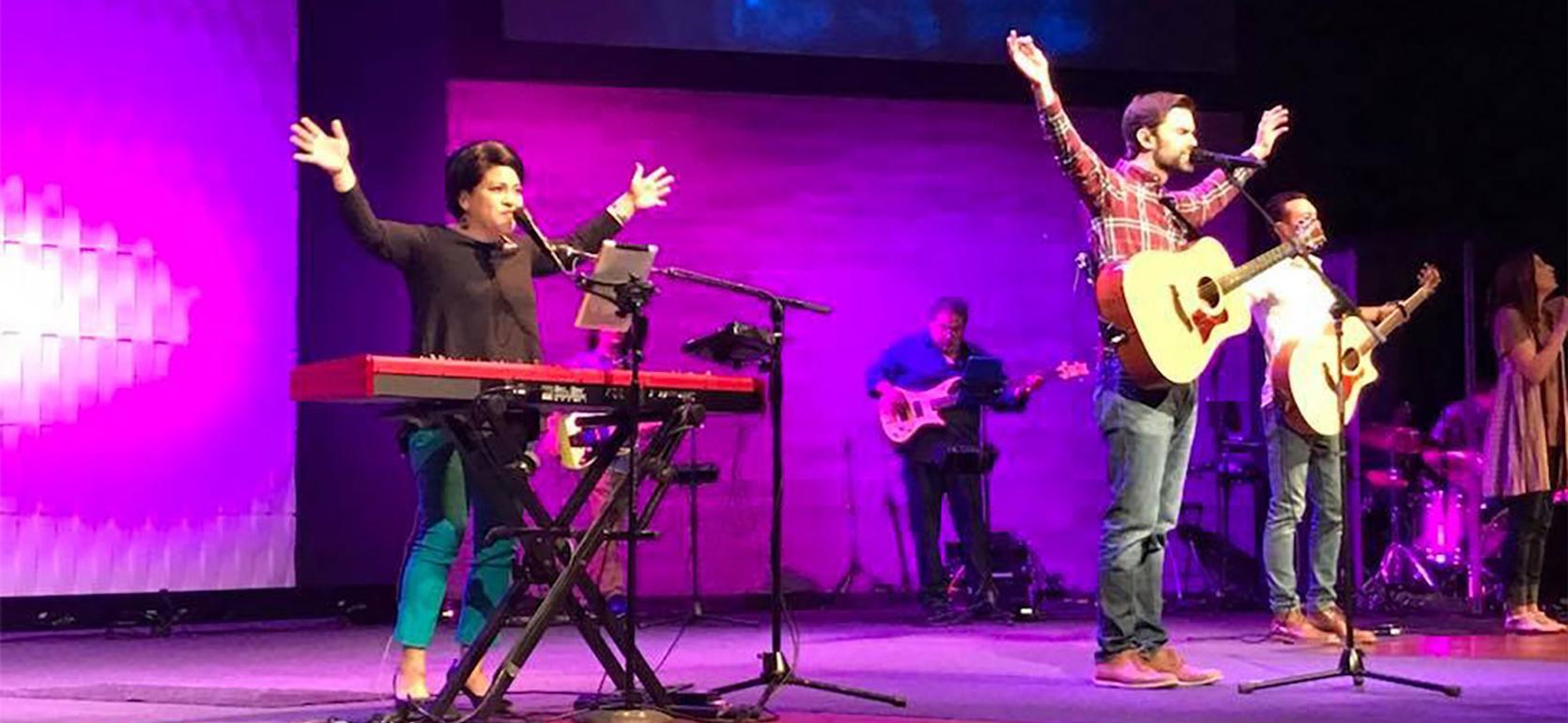 Major in music education students playing guitar, keyboard, drums and singing worship music for chapel at UMHB.