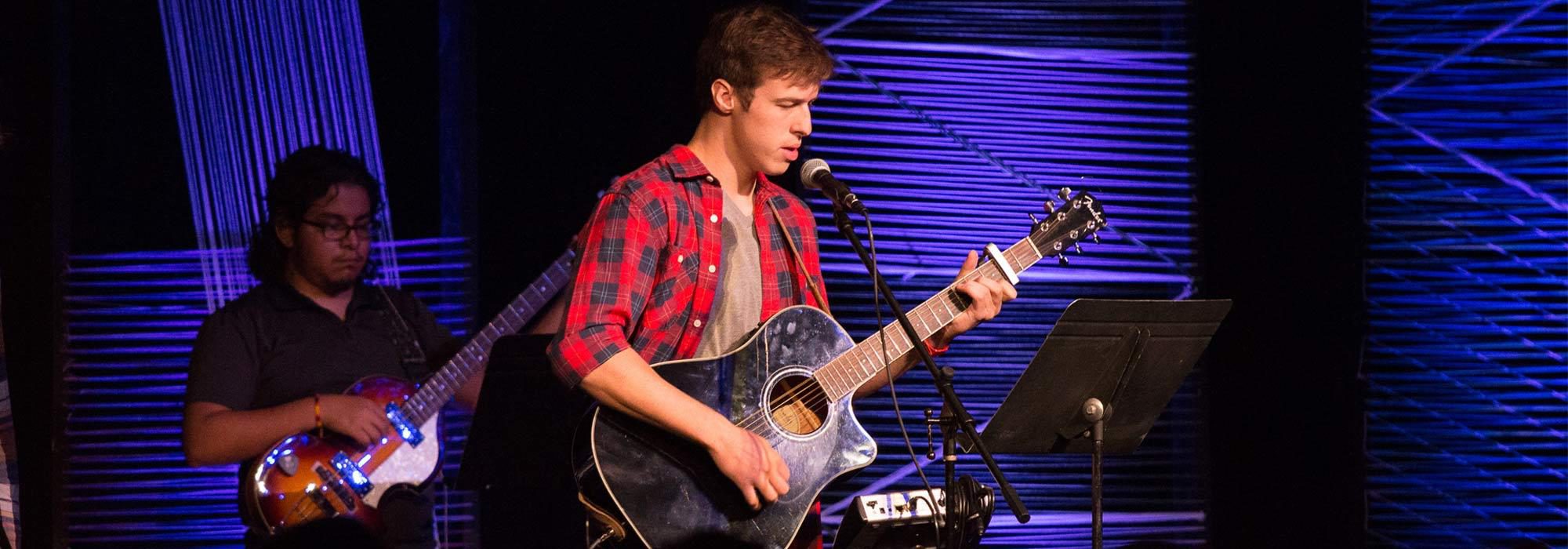 Christian music students leading worship in walton chapel playing quaitar at UMHB.