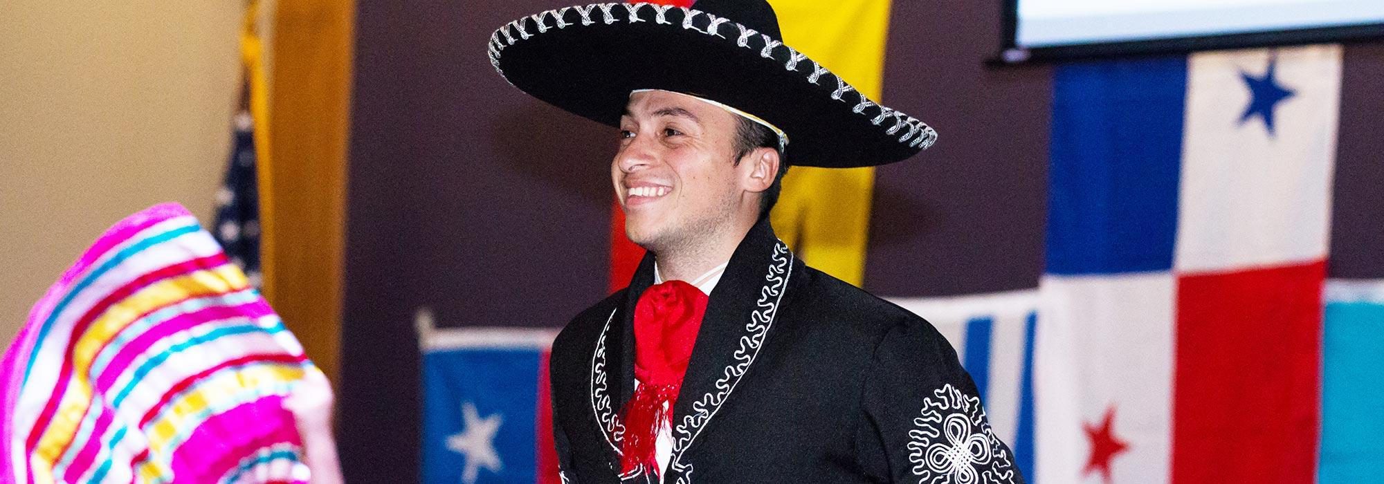 Spanish teacher, teaching immersive Spanish while wearing sombrero and traditional Spanish clothing.