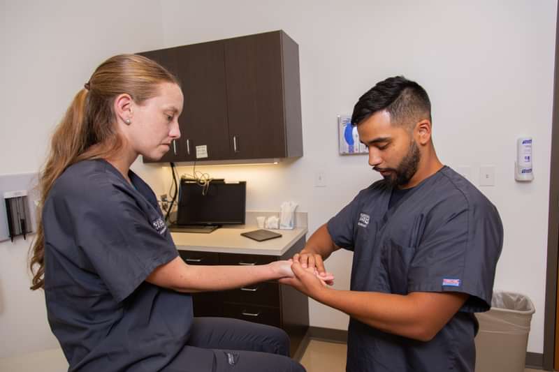 Santos "Junior" Sarabia is a student in the first cohort of the new Master of Science in Physician Assistant program. Here, he works with a fellow student on skills training.
